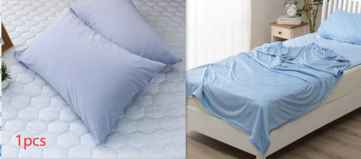 A blue polyester cooling blanket with Q-Max 0.4 technology laid on a bed.