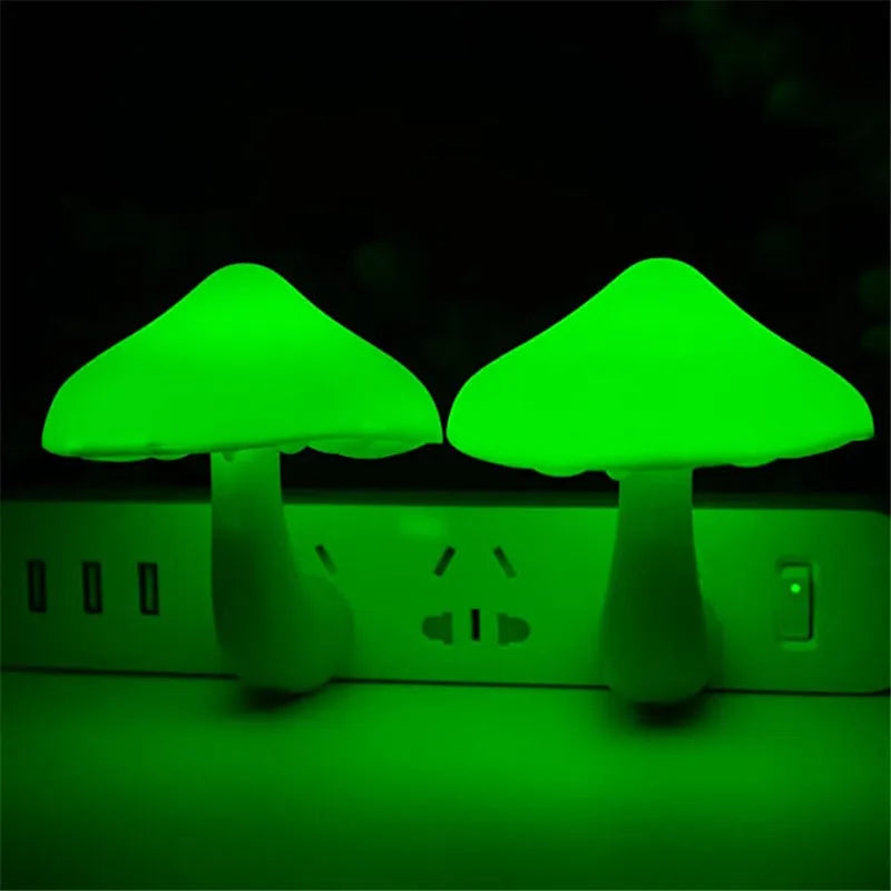 Mushroom-shaped LED night light with light sensor, warm yellow glow, plugging into a wall socket