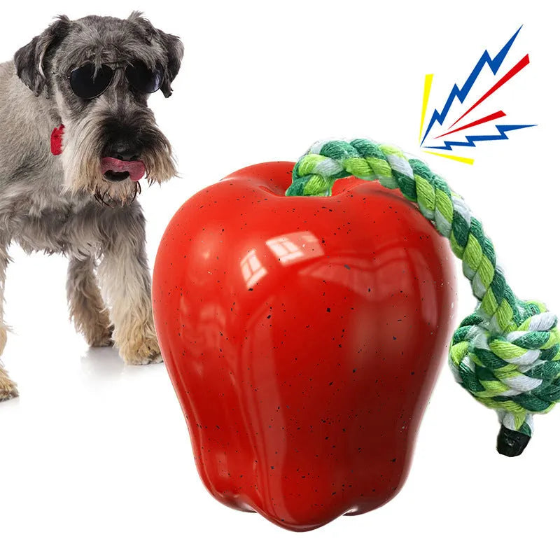 Plastic apple-shaped dog chew toy with molar texture and hollow centre for food dispensing.