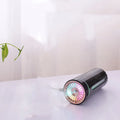 Black and white portable USB rechargeable humidifier with colourful lights for car and desktop use.