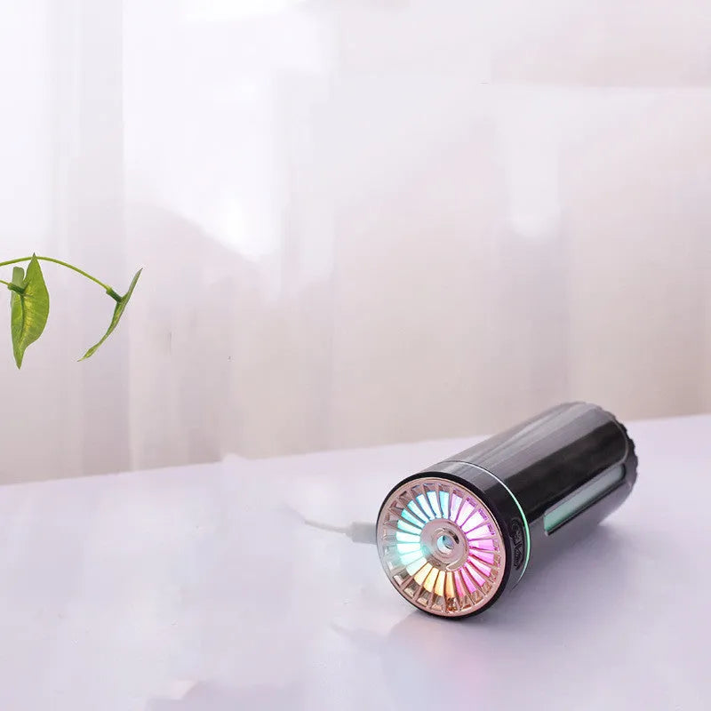 Black and white portable USB rechargeable humidifier with colourful lights for car and desktop use.