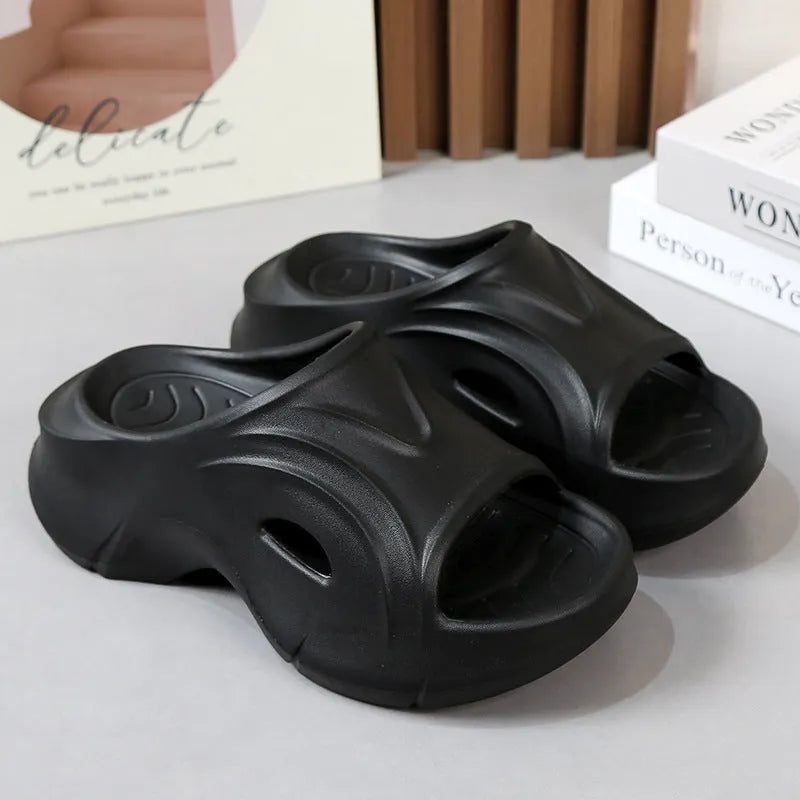 Women's white EVA slippers with a thick sole on a sandy beach background