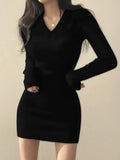 Front view of a black slim fit V-neck cotton hip skirt dress with long sleeves and elastic waist on a mannequin