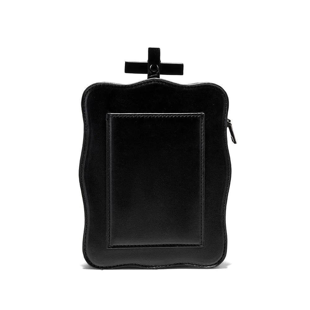 Black Gothic skull crossbody bag with embossed design, square shape, and chain detailing