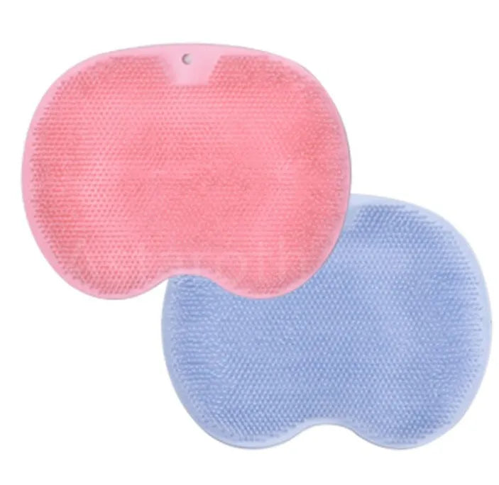 Orange TPR bath brush with silicone bristles and suction cups on base, shown on bathroom tiles.