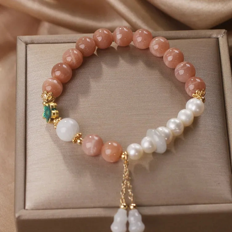 Natural sunstone bracelet with orange sunstone jade calabash pendant and moonstone beads on display