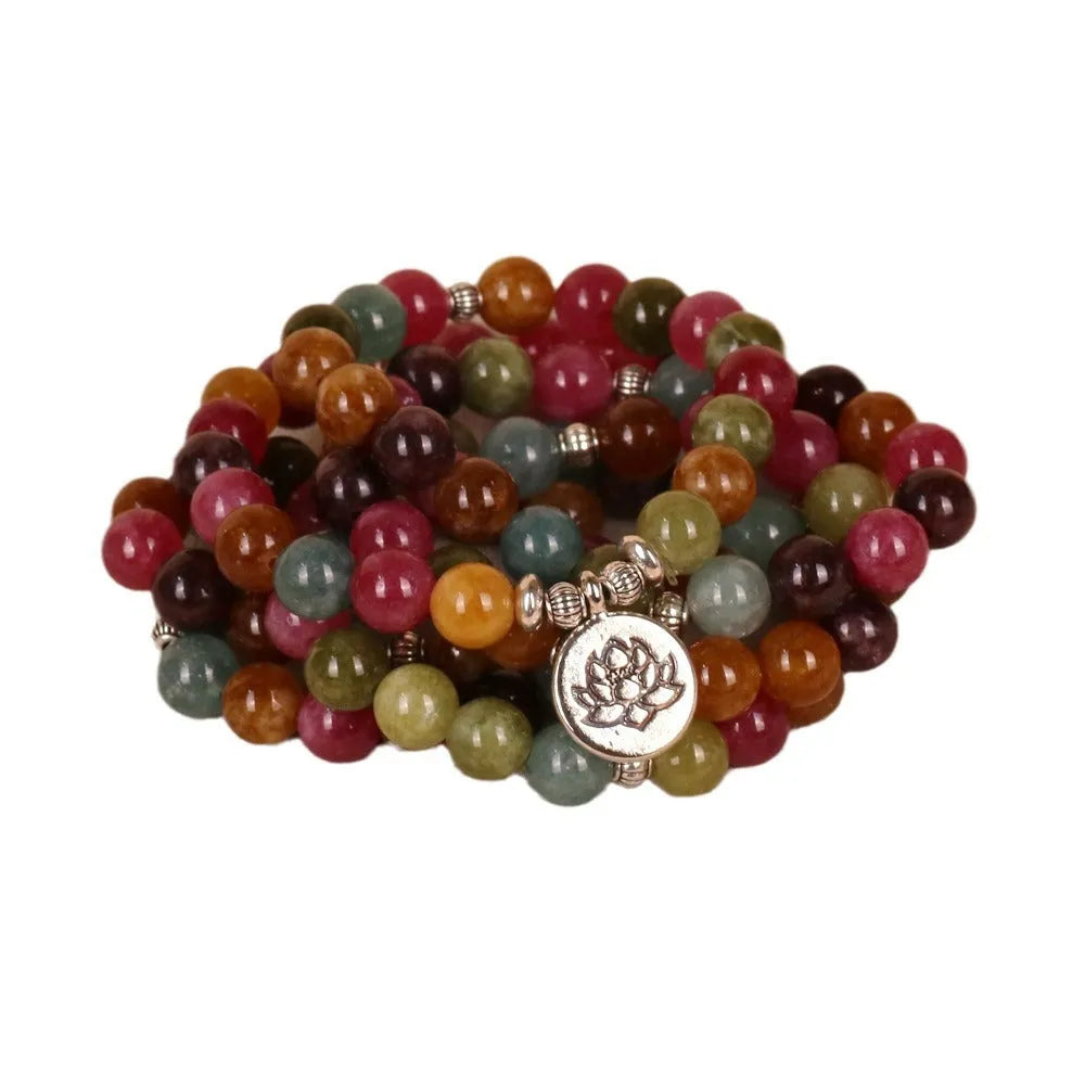 108 bead string bracelet with lotus charm in tourmaline-coloured alloy