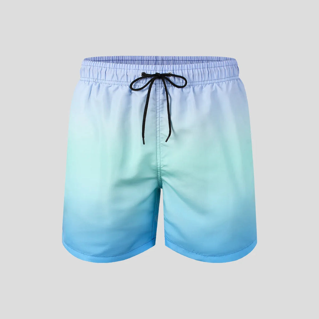 Man wearing grey gradient 3D printed mesh sports shorts against a plain background.