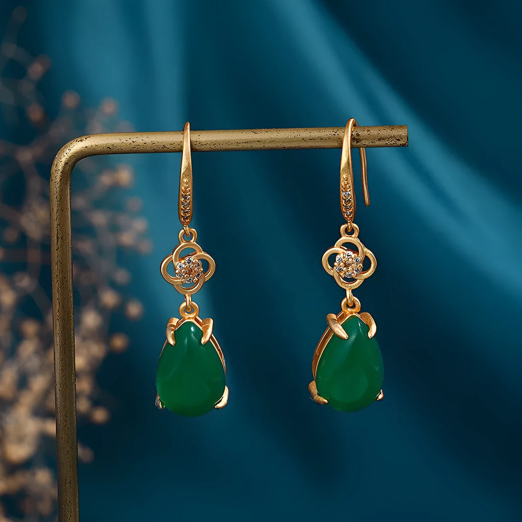 Gold-plated drop agate earrings on display showing alloy base and stone pendant