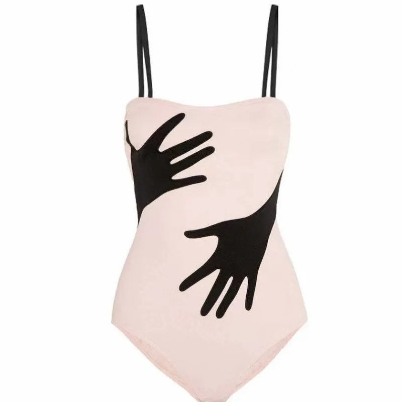 Women's one-piece bikini swimsuit with gauze skirt detail on beach