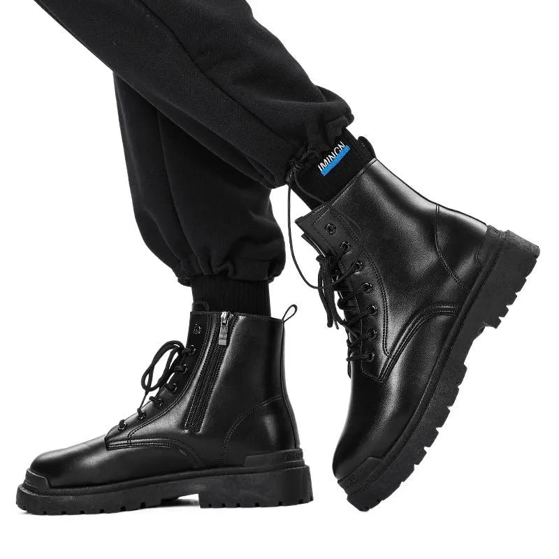 Men's mid-top black waterproof leather boots with non-slip rubber sole on flat surface