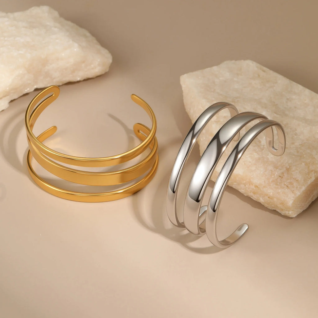 Gold and steel colour geometric line design stainless steel bracelet for women with simple opening clasp.