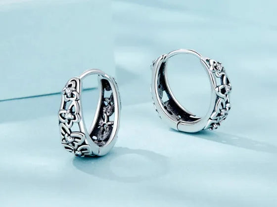 Sterling silver butterfly earrings with hollow retro design and zircon accents