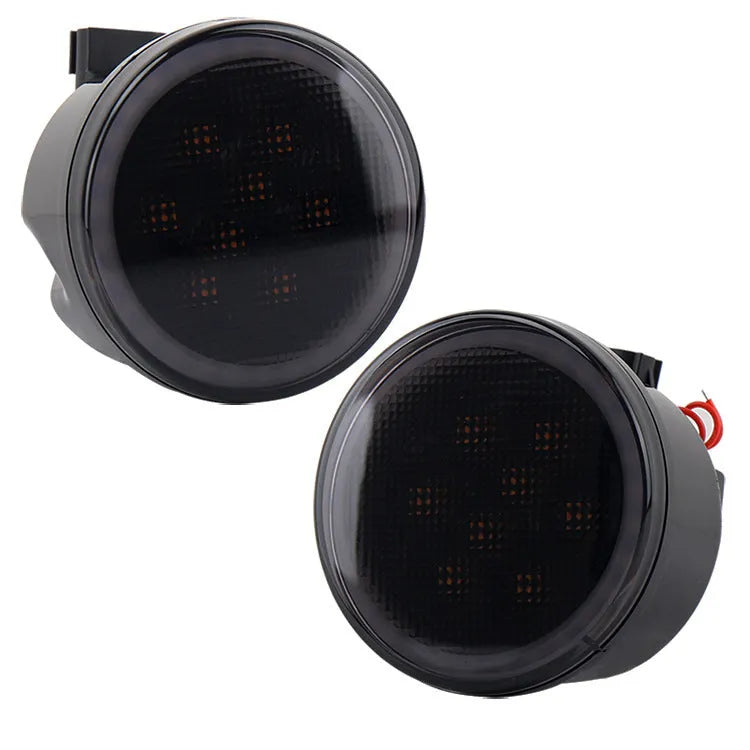 Pair of yellow LED turn signal lights mounted in Jeep Wrangler JK centre grille with ABS polymer housing