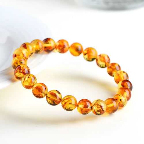 Natural yellow piebald amber bracelet with polished geometry beads and flower spot patterns
