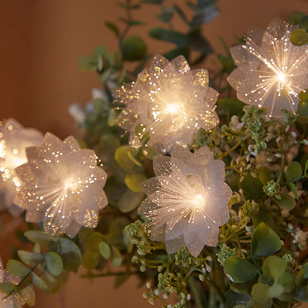 LED optical fibre flower light string with battery box, 20 warm white beads on a dark background