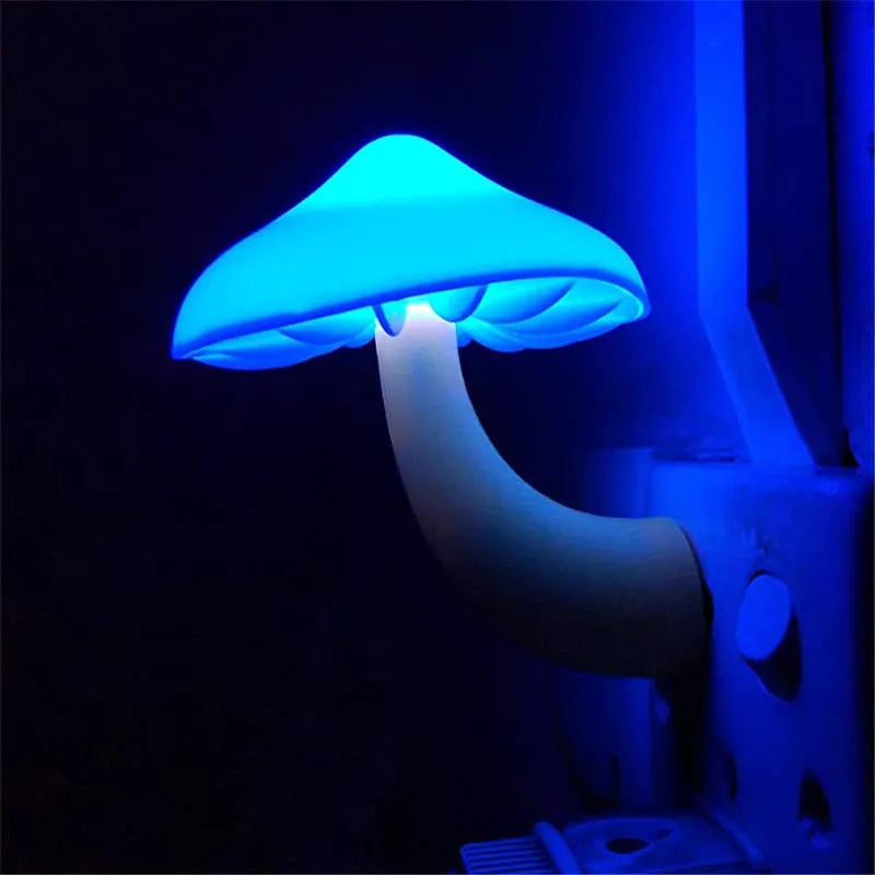 Mushroom-shaped LED night light with light sensor, warm yellow glow, plugging into a wall socket