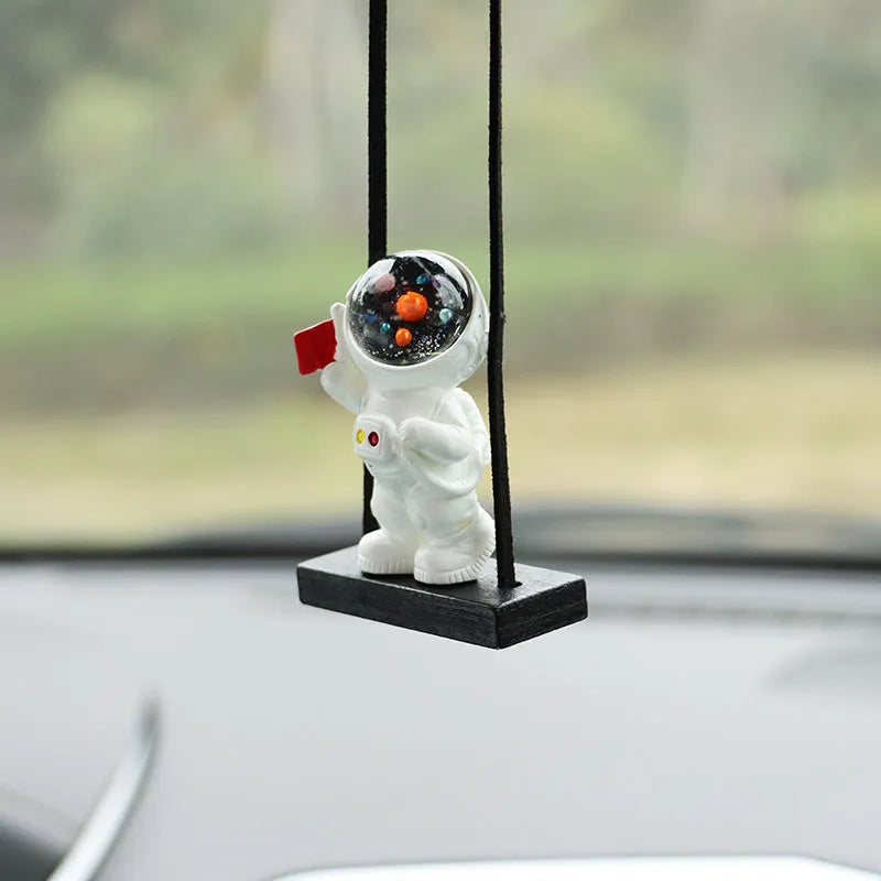 Resin cartoon astronaut car pendant decoration hanging from a rear-view mirror.