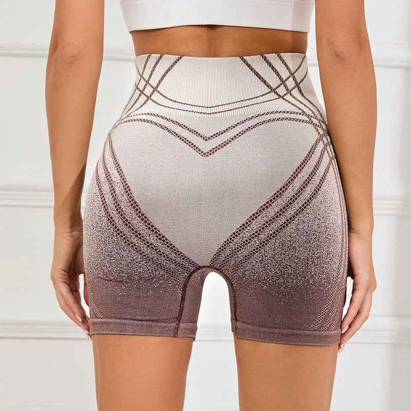 Women's high waisted gradient fitness shorts in black, shown with Spider-Man graphic.