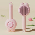 Self-cleaning pet grooming brush with green handle and stainless steel comb, showing the release button.