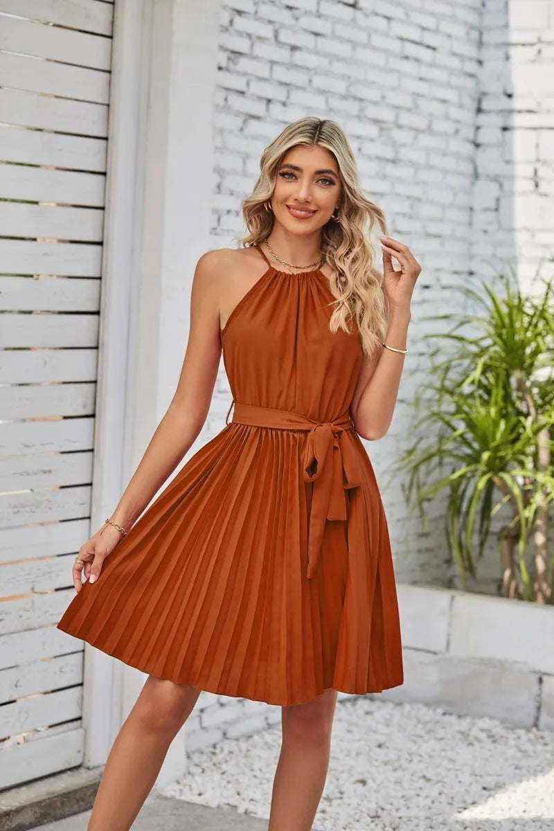 Women's black halter neck strapless sundress with a pleated midi skirt and an adjustable waist belt.