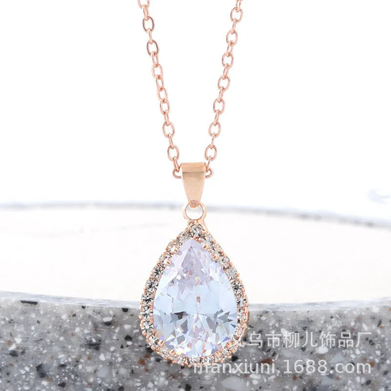 Rose gold geometric drop necklace with rhinestone details in pink colour option