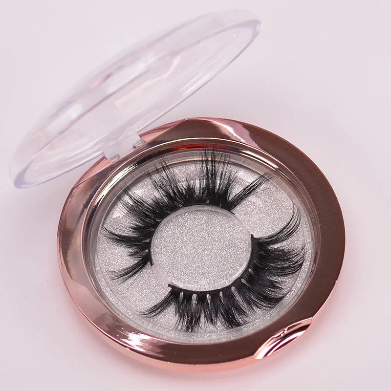 5D mink hair false eyelashes set with brush and storage cap on pink background.