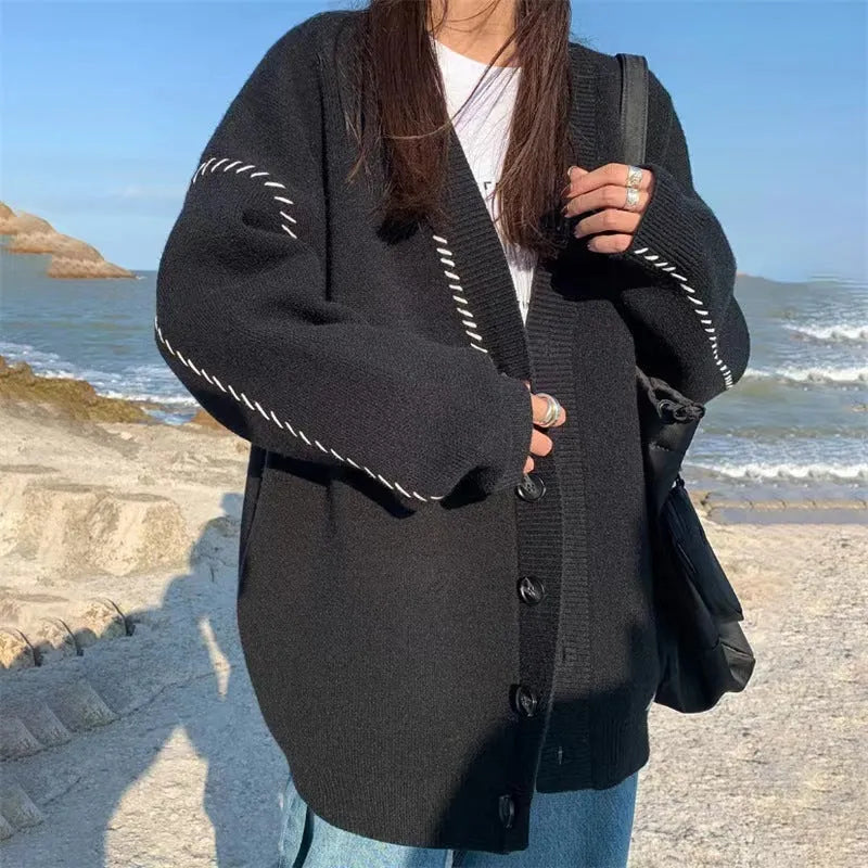 Women's knitted cardigan top coat in black or white with loose fit and long sleeves