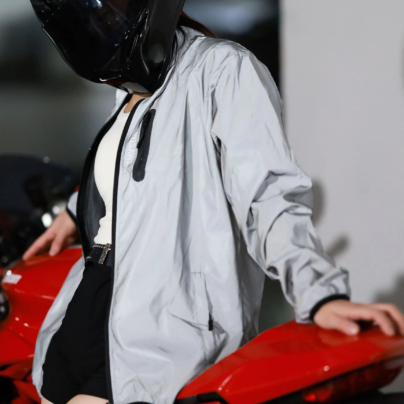Silver waterproof polyester long sleeved jacket for outdoor wind and rain protection.