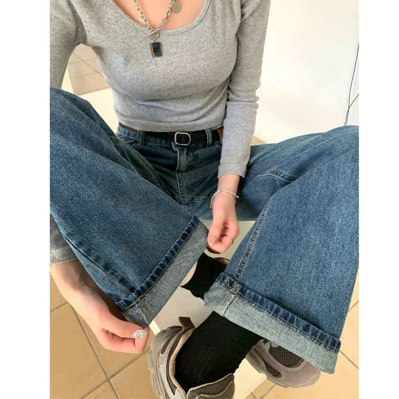 Women's high-waisted retro straight jeans in medium blue denim, showing straight leg and high waist silhouette.