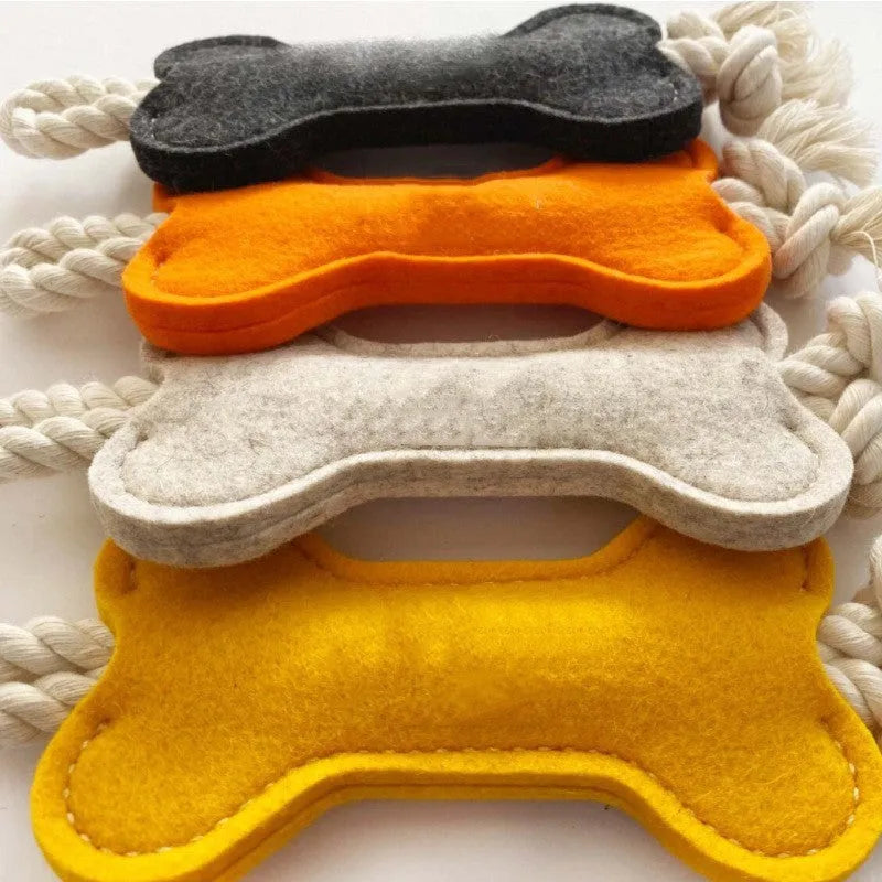 Bone-shaped dog chew toy with felt exterior showing rope knot texture inside, 16cm long in blue colour