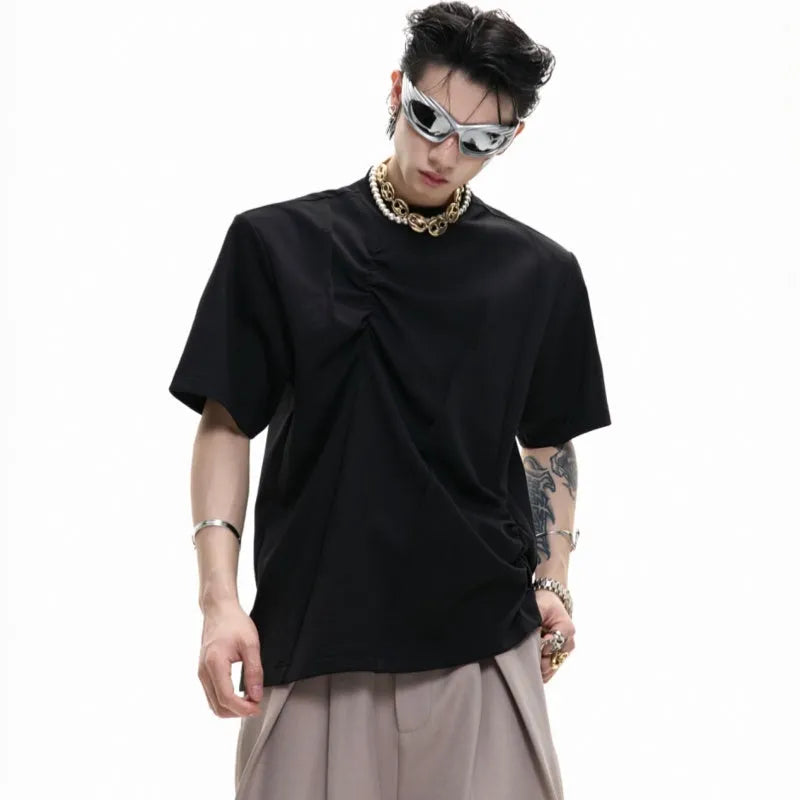 Man wearing a black cotton t-shirt with textured 3D pleating and a round neck