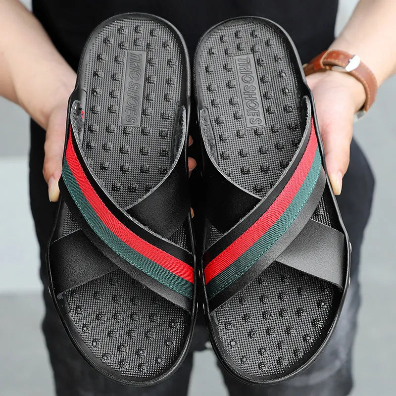 Men's white cowhide leather flip flops with a non-slip PU sole on a beach background.