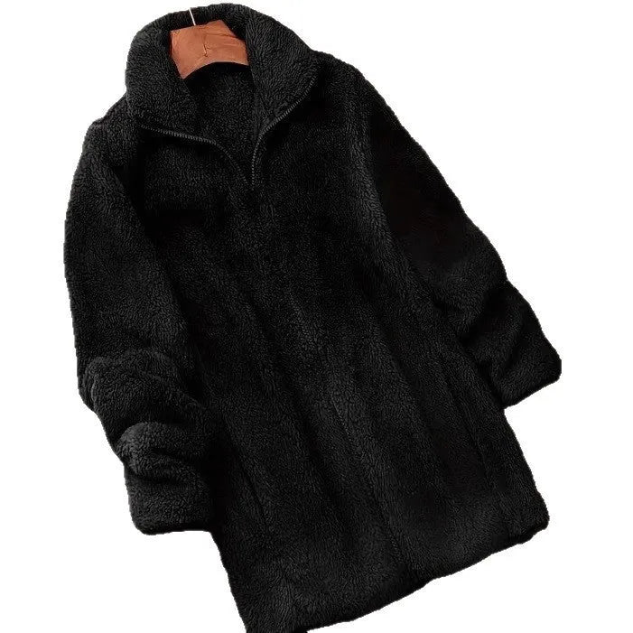 Man wearing a black double-sided fleece jacket outdoors, showing soft texture.