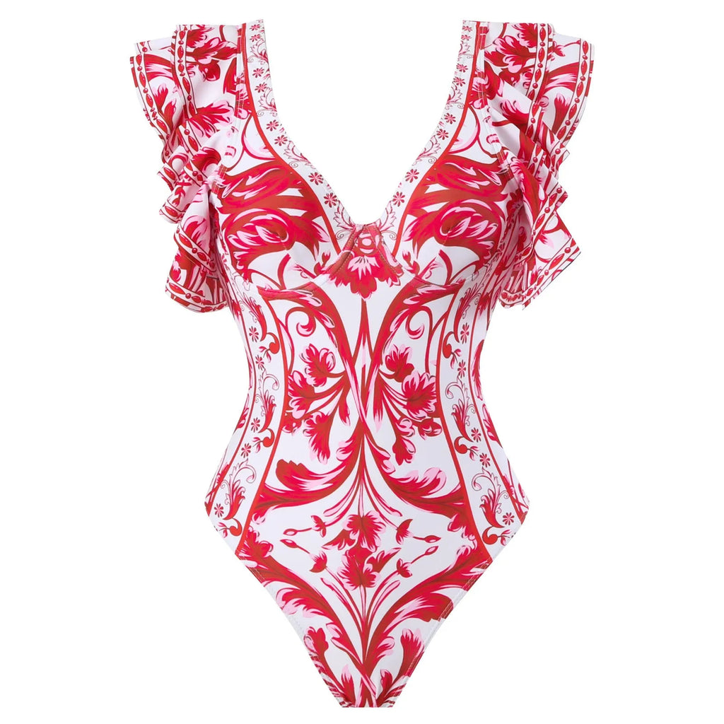 Adult woman modelling a printed one-piece swimsuit with a skirt detail in a blue colour.