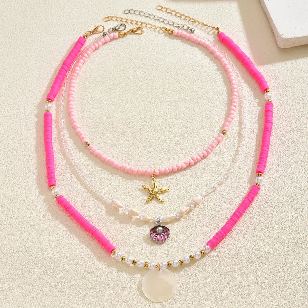 Polymer clay beaded necklace with multi-layer twin clavicle chain and geometric alloy pendant on female model
