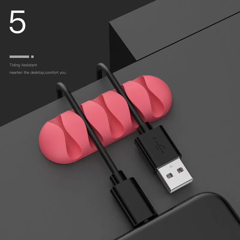 Smart cable holder with TPR flexible clips in black holding USB earphone and network cables on a desk