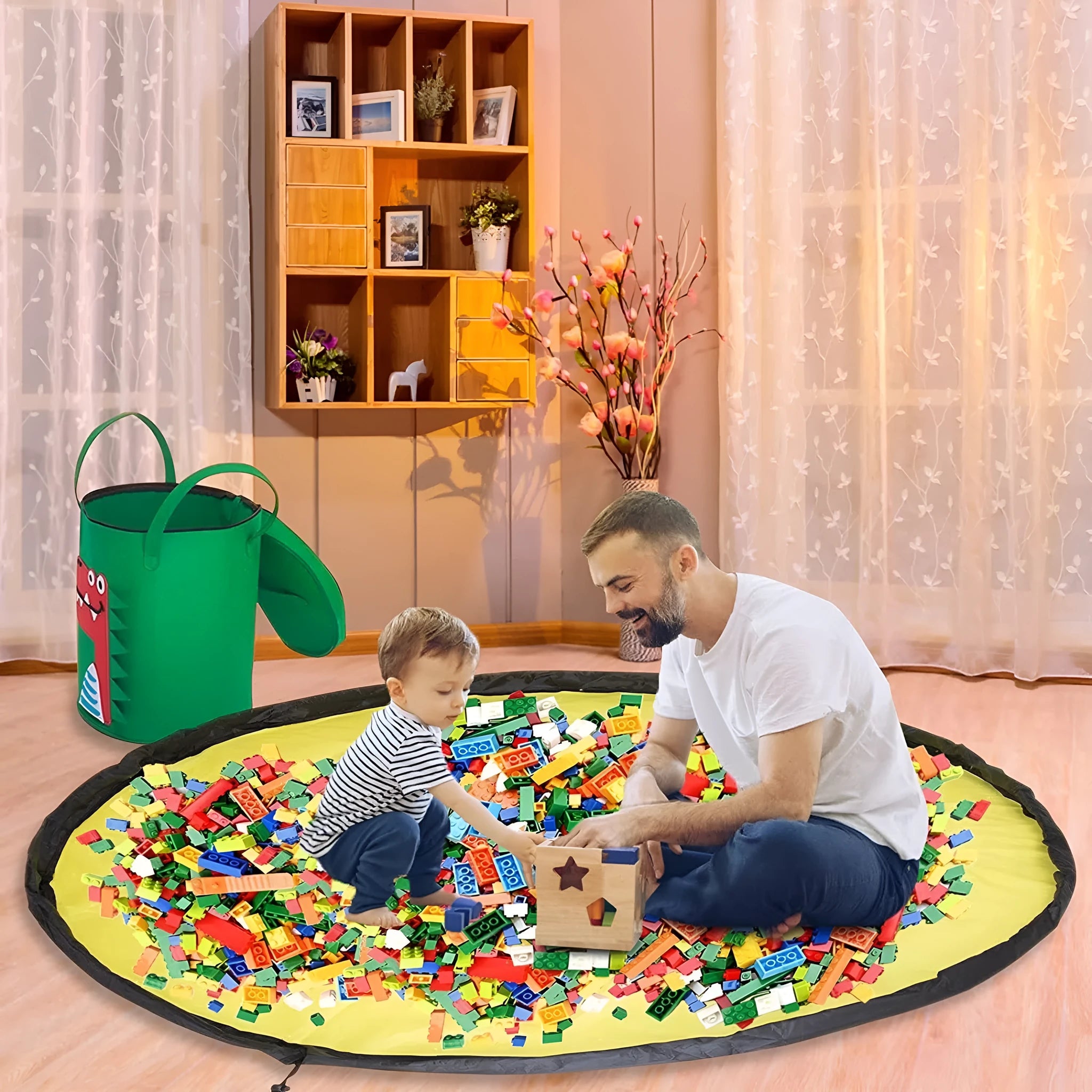 Green felt cube storage bag with pull rope, laid flat as a play mat for toys.
