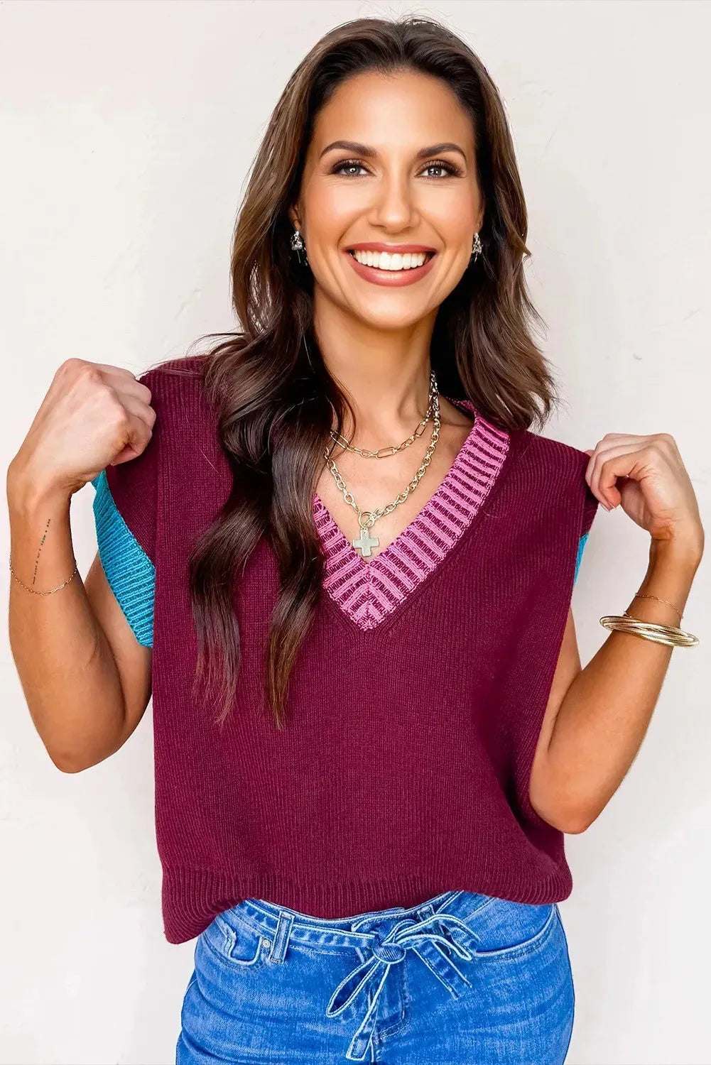 Burgundy loose V-neck short sleeve sweater with contrast trim detail on the neckline and cuffed sleeves.