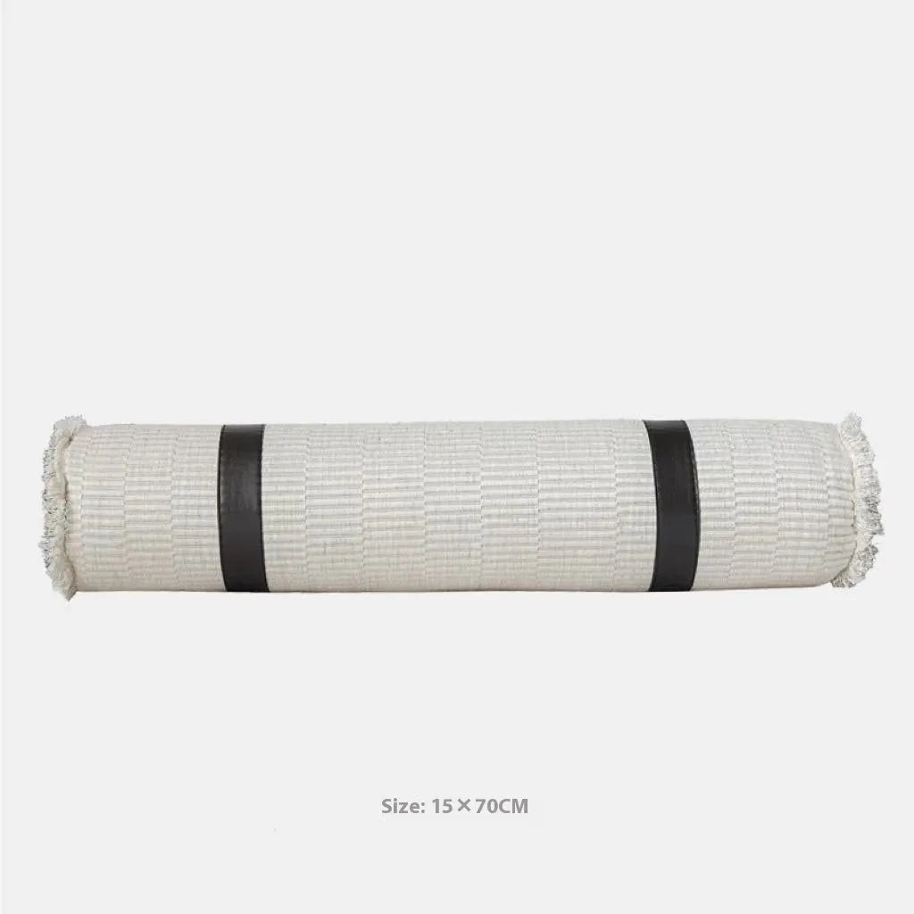 Modern minimalist grey and white plaid bed runner blanket with matching pillowcase and round pillow on a double bed.