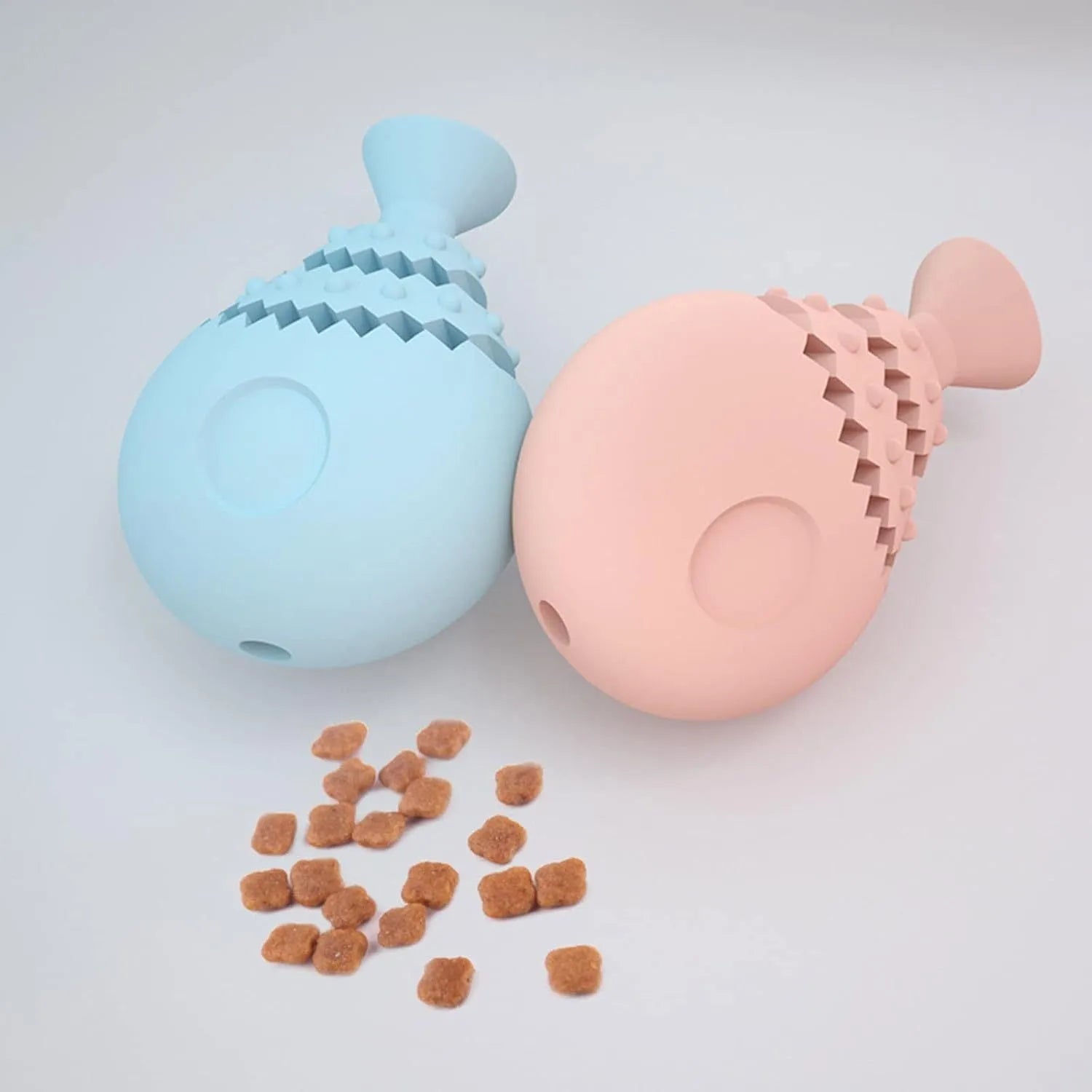 Blue fish bone shaped dog chew toy with hollow centre for treats, shown next to a green and pink version.