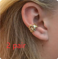 Gold-coloured starfish and scallop shell dangle earrings for women on a white background.