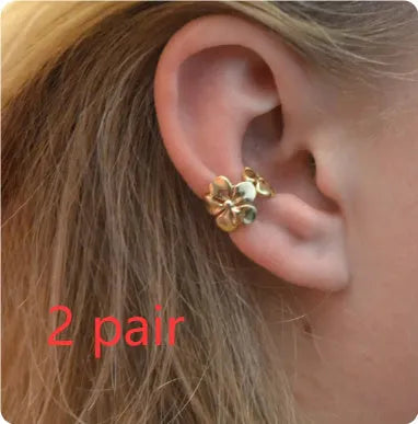 Gold-coloured starfish and scallop shell dangle earrings for women on a white background.