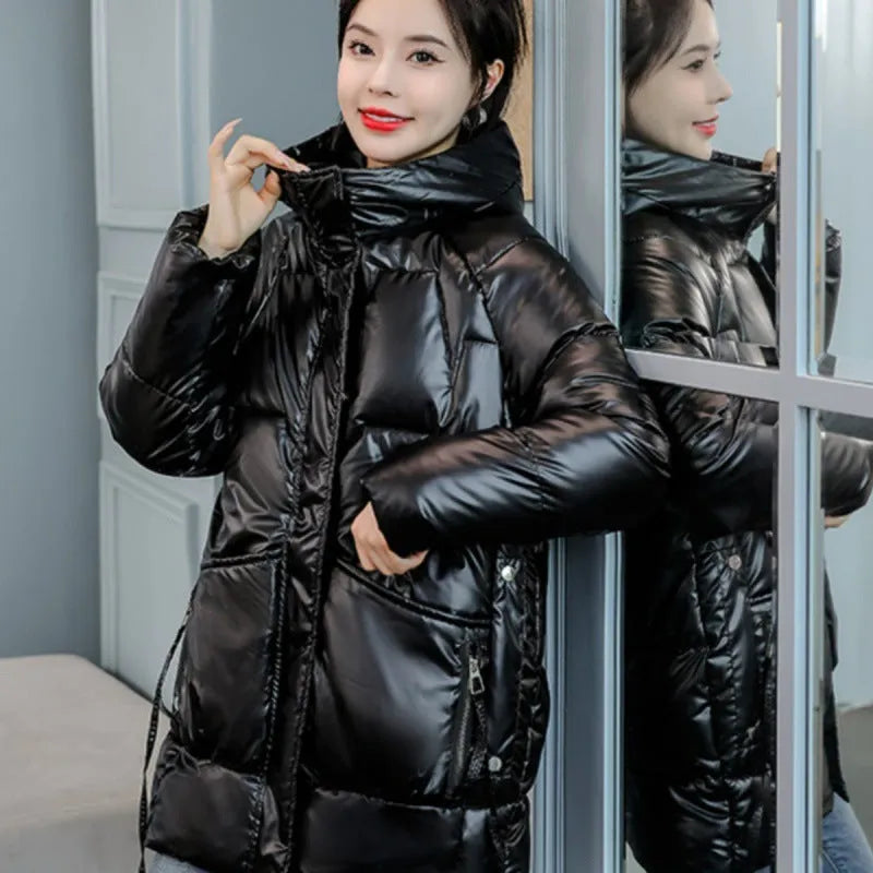 Woman wearing a loose-fit green hooded winter jacket with long sleeves.