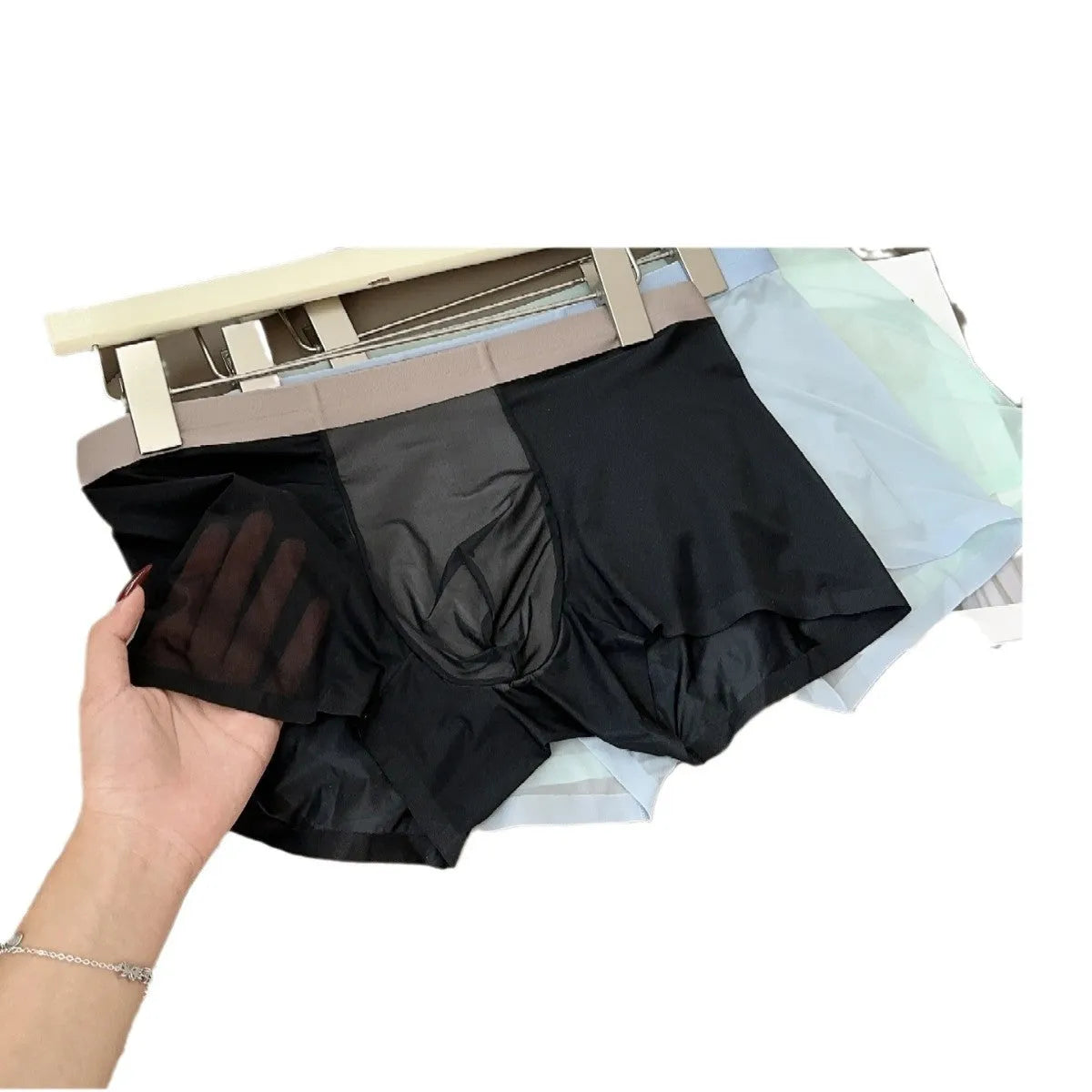 Seamless men's boxer shorts in ultra-thin ice silk nylon fabric, showing honeycomb crotch design.