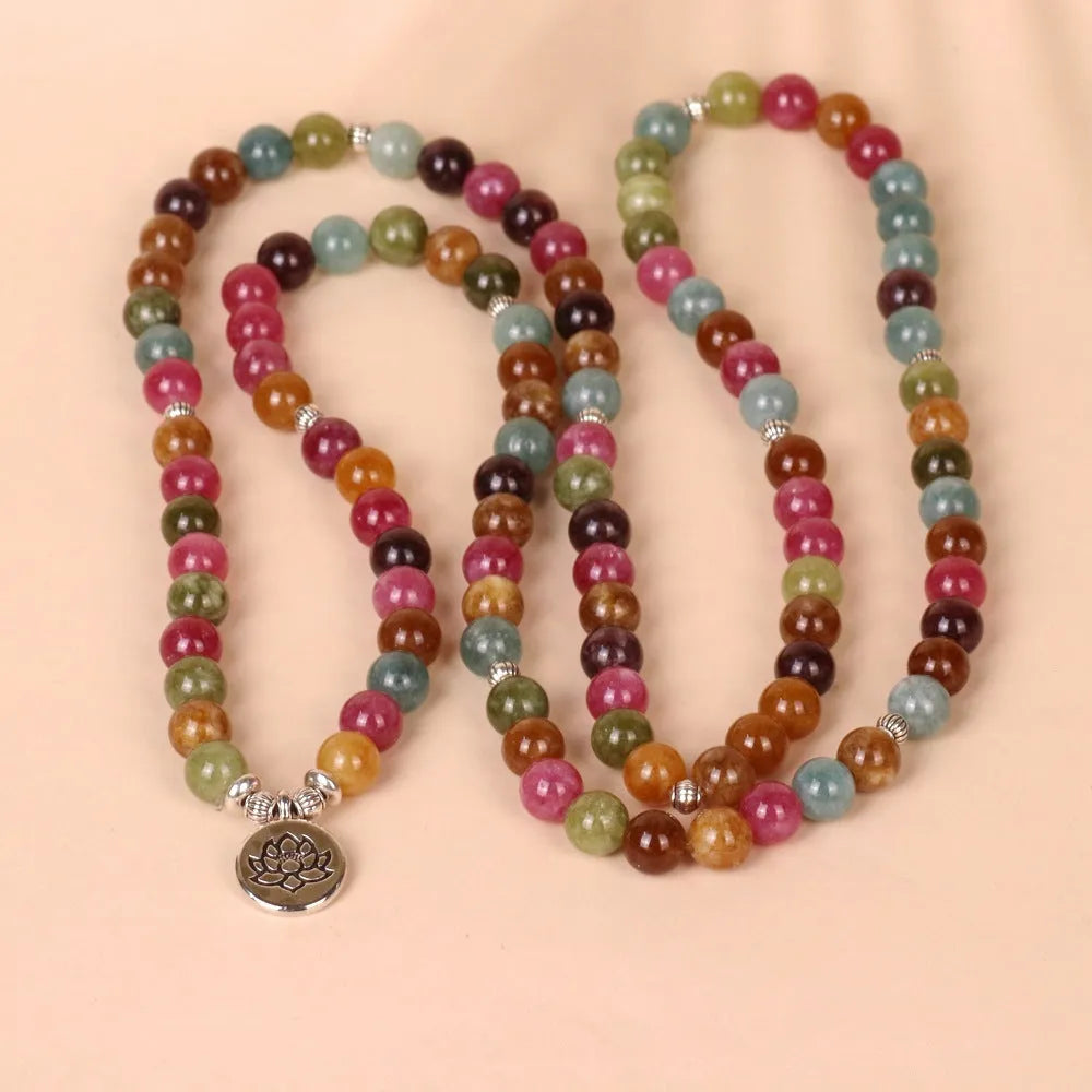 108 bead string bracelet with lotus charm in tourmaline-coloured alloy