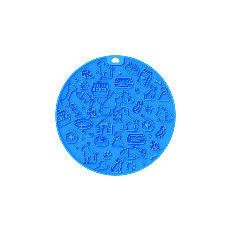 A blue silicone pet licking mat with a suction cup base on a kitchen floor.