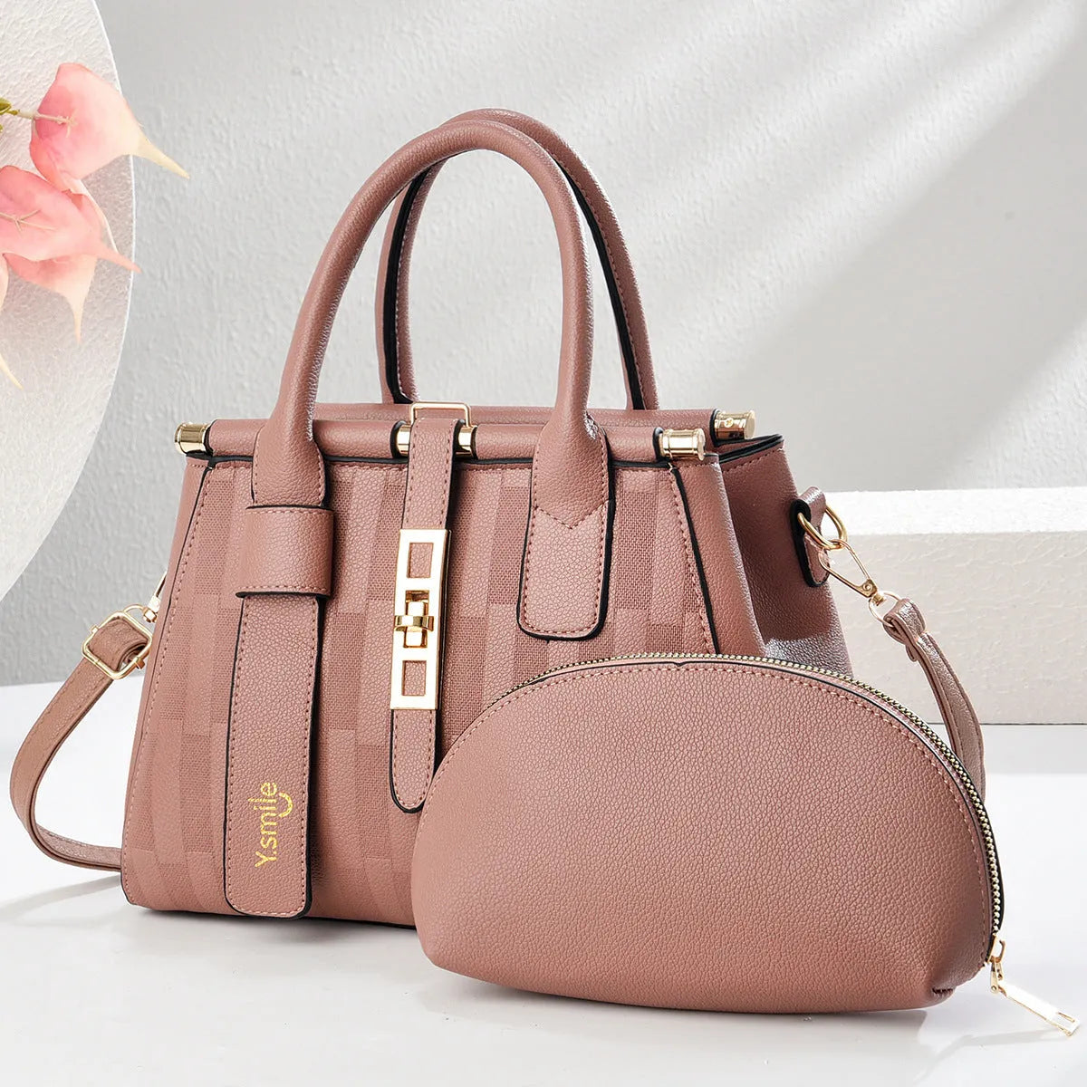 Round black PU handbag with crossbody strap shown alongside light khaki and purplish red colour options
