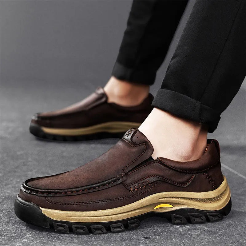 Men's black thick-soled mountaineering boots with round toe and rubber sole.