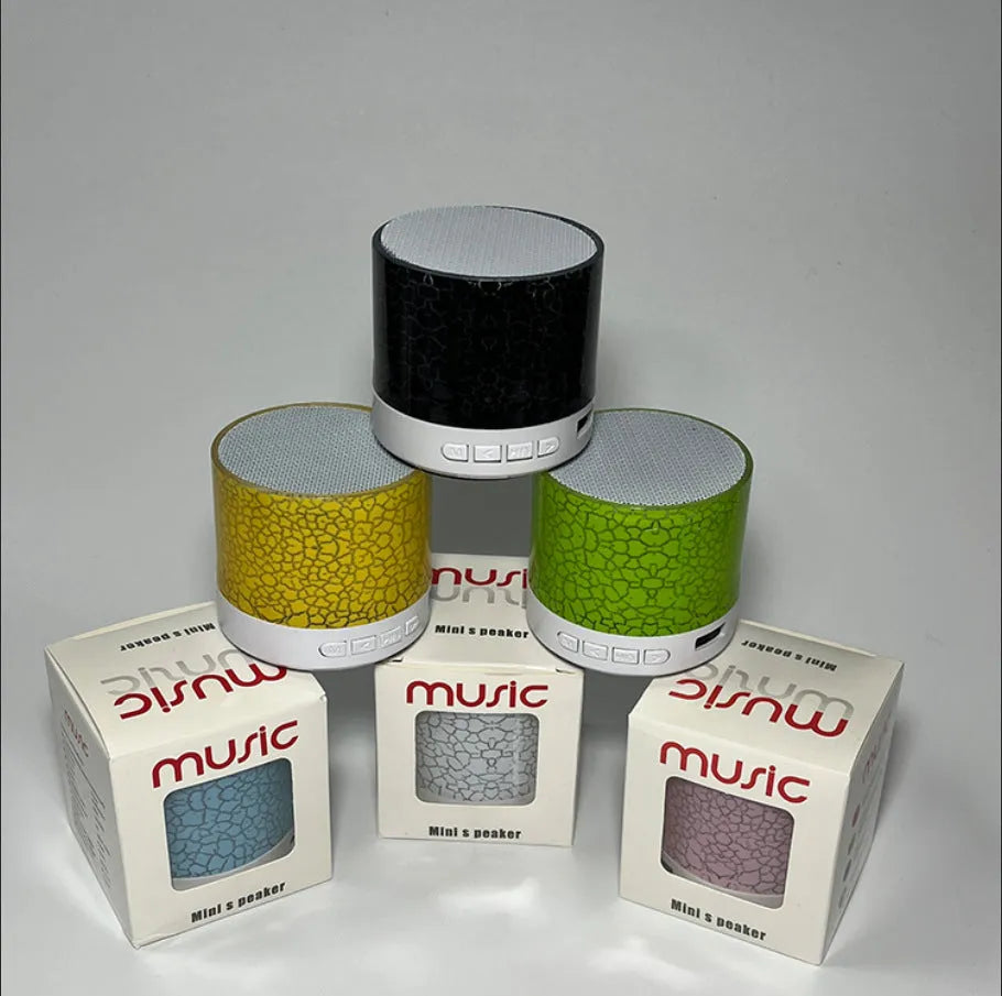 A9 Mini Cracked Bluetooth Speaker in blue with LED lights on a table